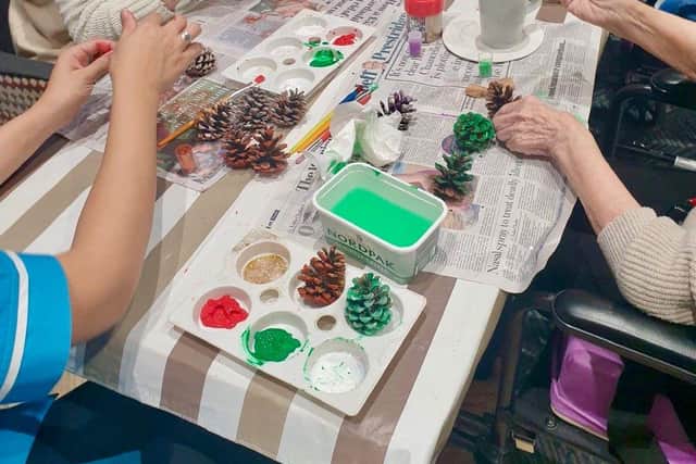 Residents hard at work decorating the pine-cones