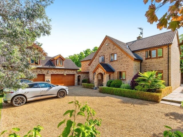 The home is stunningly presented with an arched porch, a large driveway with space for multiple cars and an adjacent garage