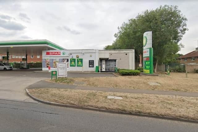 The woman was using the cash machine at the petrol station in Mill Lane.