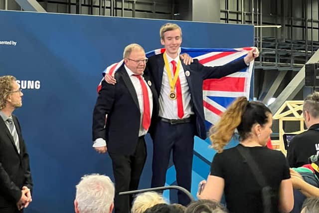 James Boyes with UK training manager Christian Notley after winning gold in cabinet making at the Basel award ceremony 