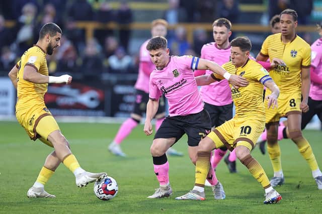 Sam Hoskins battles for possession in the Cobblers' win at Sutton United (Picture: Pete Norton)