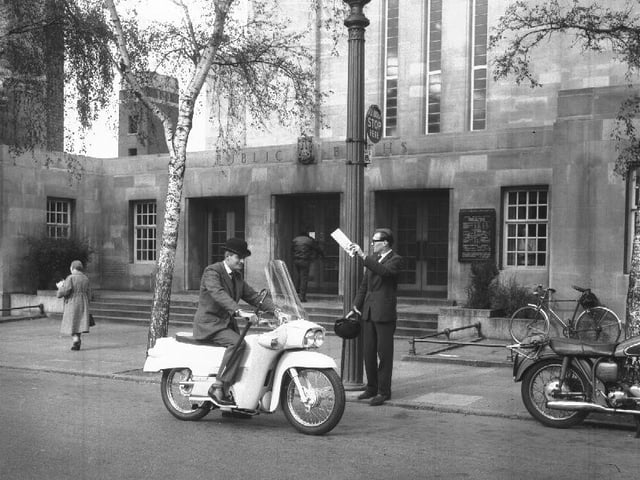 City toff on an enclosed Velocette motorcycle outside the Mounts Baths, Northampton
