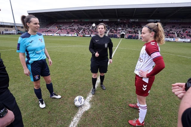 Referee Katie Dorling performs the coin toss with captains Megan Cann and Zoe Boote