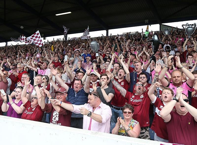 Northampton Town fans welcome there team on the pitch prior to the Sky Bet League Two match between Portsmouth and Northampton Town at Fratton Park on May 7, 2016.