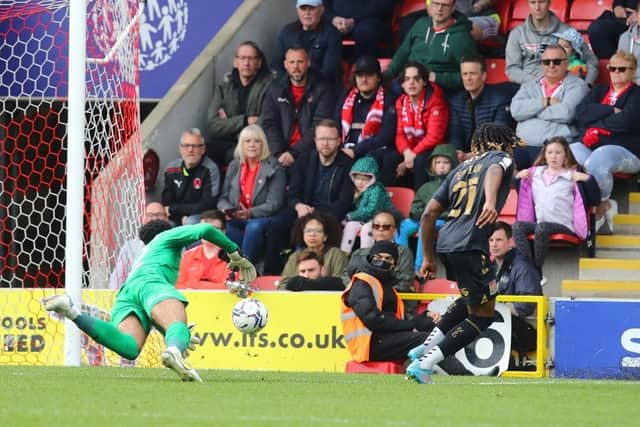 Josh Eppiah rounds Lawrence Vigouroux to make it 3-0 to the Cobblers.