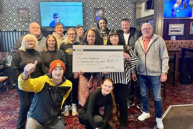The Bear team and customers with The Lewis Foundation's Lorraine Lewis.