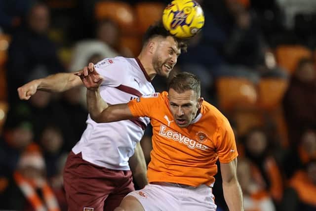 Cobblers defender Sam Sherring challenges with Blackpool's Jordan Rhodes (Picture: Pete Norton)
