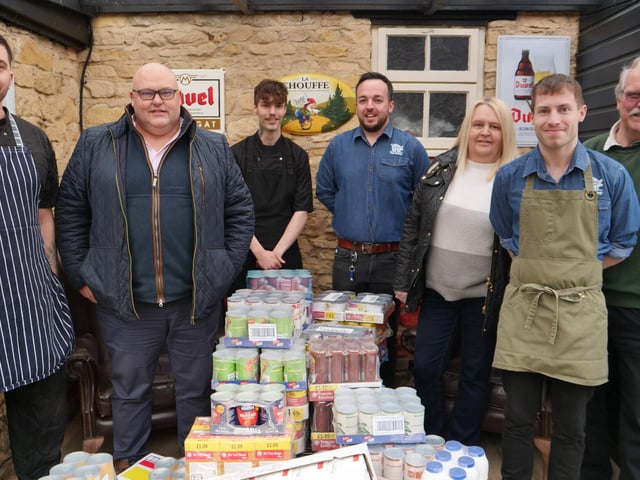 Richard Gordon and the Greedy Gordons team handover donations to Ken Ansdell from Kettering Foodbank.