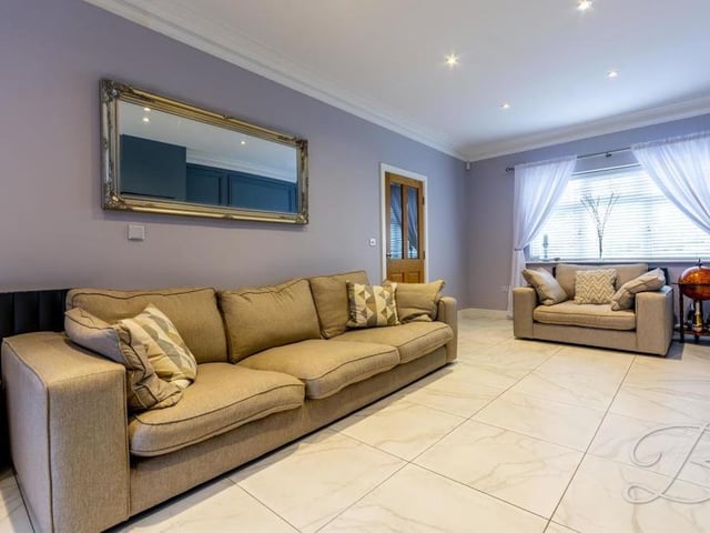 The size of the living room does not detract from its comfort. A tiled floor and ceiling downlights add to its appeal.