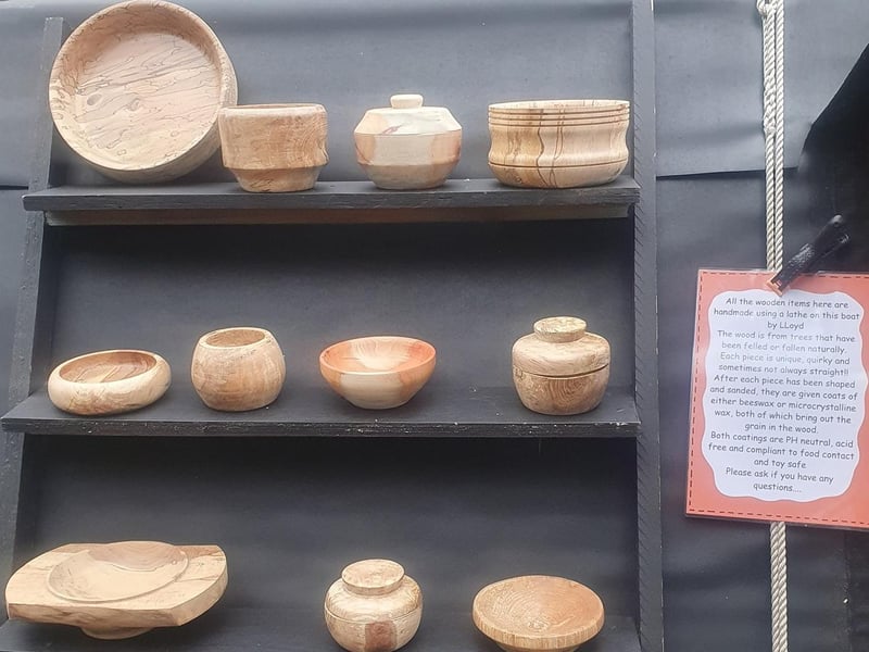 Handmade wooden items pictured, including various bowls and pots, made on board by Lloyd.