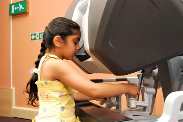 Saee, six, playing on the demonstration robot.