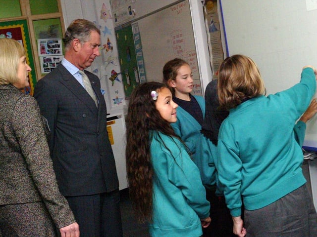 Prince Charles watches a lesson with children at Upton Meadows school