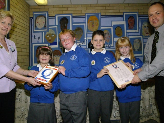Ecton Brook Primary School receive award for quality on their basic skills. Adults in pic are Deputy Head Mr Smith and Stephanie Beckett from Northamptonshire County Council