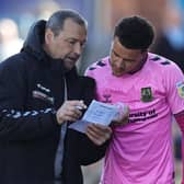 Shaun McWilliams receives instructions from Colin Calderwood before coming on against Carlisle