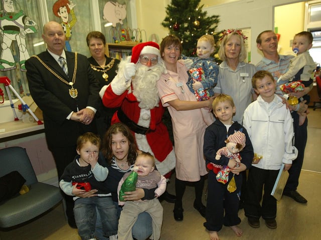 Northampton Mayor and Mayoress Colin and Judith Lill with Father Christmas, staff, parents and patients from Paddington Ward at Northampton General Hospital.