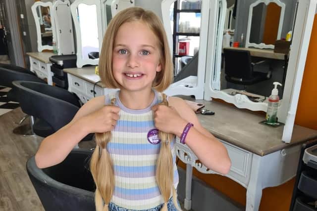 Penny Newton, aged 8, after having over 14 inches of her hair cut for The Little Princess Trust.