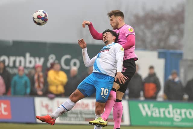 Sam Sherring climbs well to win a header.