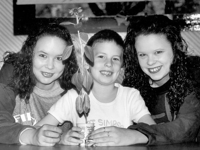 Daniel, Melissa and Maria Henson with a tiny sunflower 1991
