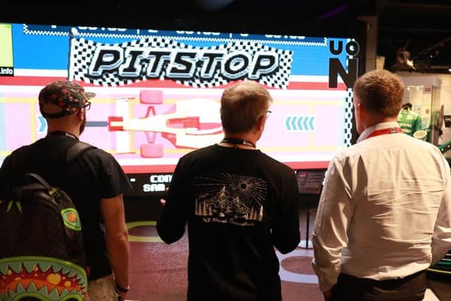 Visitors stand in front of screen at Silverstone Museum.