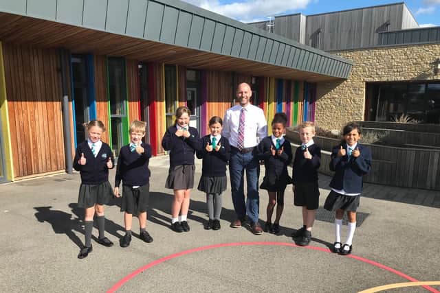 The headteacher and some of the pupils at Silverstone Primary School.