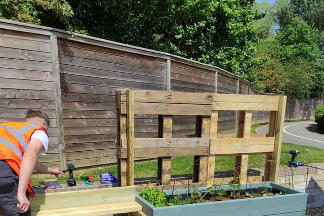 A Moulton College construction student at work in the community garden