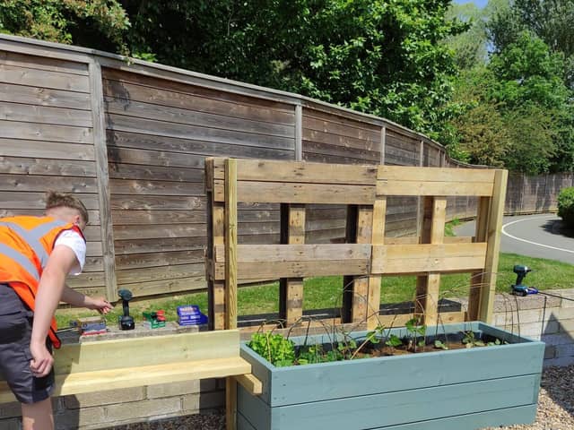 A Moulton College construction student at work in the community garden
