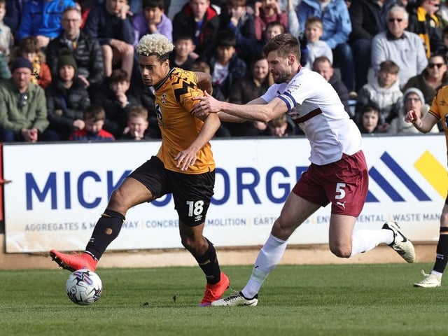 CAMBRIDGE, ENGLAND - MARCH 09: Lyle Taylor of Cambridge United attempts to move with the ball away from Jon Guthrie of Northampton Tow during the Sky Bet League One match between Cambridge United and Northampton Town at Cledara Abbey Stadium on March 09, 2024 in Cambridge, England. (Photo by Pete Norton/Getty Images) : Last club: Cambridge UnitedPosition: Attacker