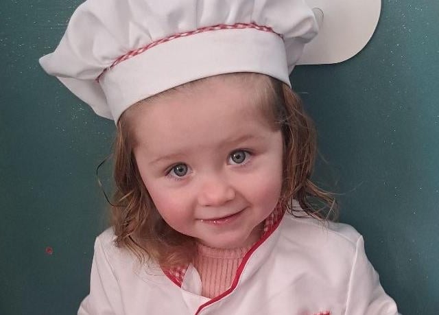 Elsie, aged two, as the Little Chef.