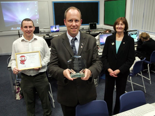 Northampton School For Girls has won a business award for their music department. L-R are Greg Myles, Paul Parker and Head Teacher Penny Westwood with the award