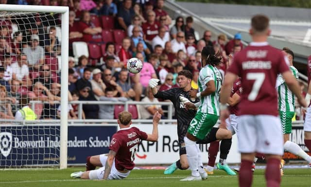 Max Thompson sees the ball slip from his grasp allowing Wycombe to score the only goal of the game at Sixfields on Saturday.