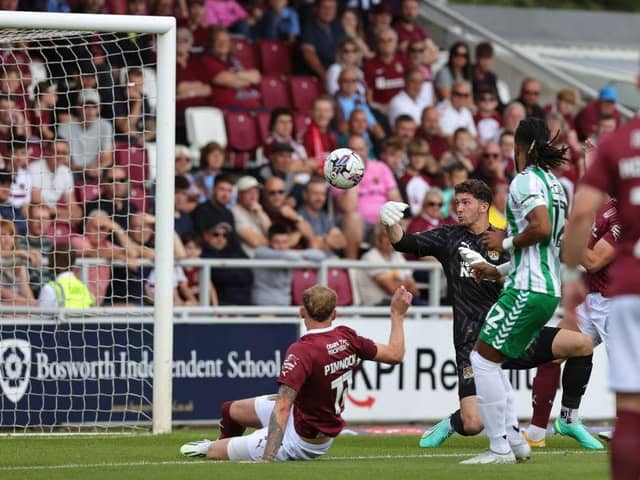 Max Thompson sees the ball slip from his grasp allowing Wycombe to score the only goal of the game at Sixfields on Saturday.