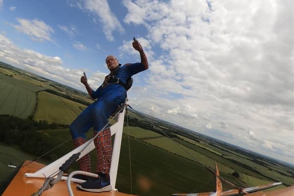 Richard was dressed as Spiderman as he was strapped to the top of a 1940s biplane, 800 feet in the air travelling at 130 miles per hour.