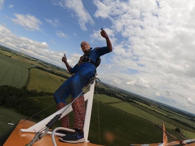 Richard was dressed as Spiderman as he was strapped to the top of a 1940s biplane, 800 feet in the air travelling at 130 miles per hour.