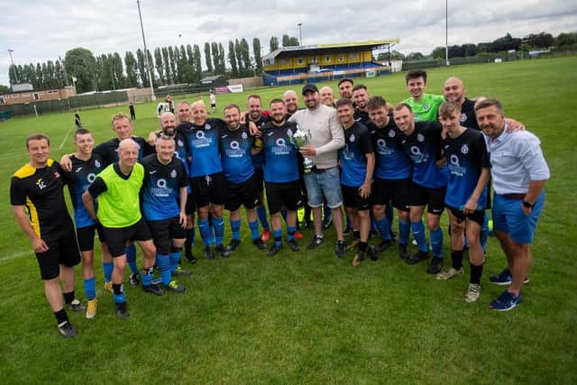 PC Jack Watts (centre, holding the trophy) with members of the victorious NorPol football team