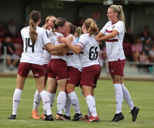 Alex Dicks is congratulated by team-mates after scoring her side's first goal during the National League Division One Midlands match between Northampton Town and Peterborough United at Fernie Fields. (Photo by Pete Norton/Getty Images)