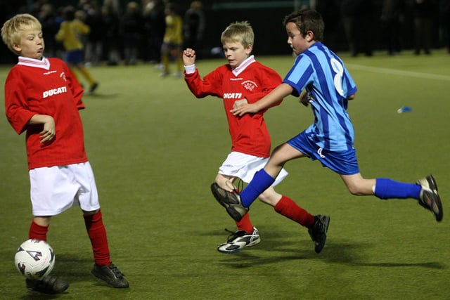 Football action from Hunsbury Park Primary School (blue) v Hopping Hill Primary School (red).