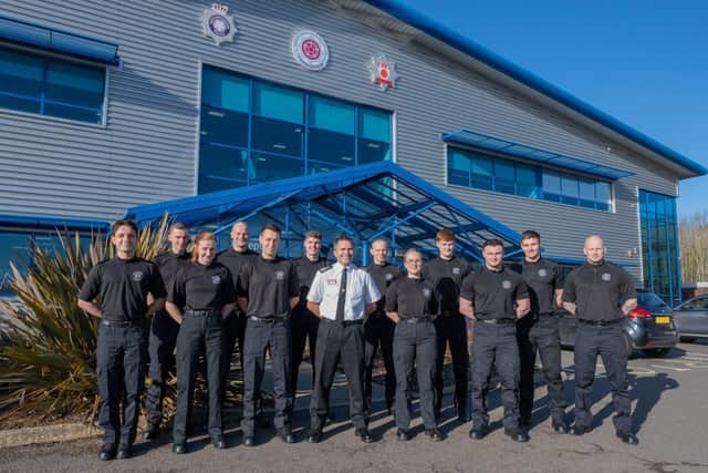 Twelve new firefighters stood outside NFRS HQ with Acting CFO Simon Tuhill