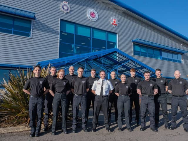 Twelve new firefighters stood outside NFRS HQ with Acting CFO Simon Tuhill