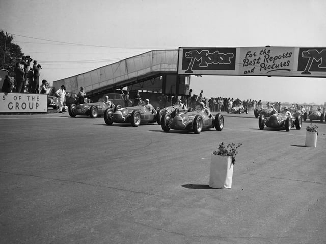 Juan Manuel Fangio from Argentina driving the #1 Alfa Romeo SpA Alfa Romeo 158 leads Luigi Fagioli from Italy in the #3 Alfa Romeo SpA Alfa Romeo 158 and Giuseppe "Nino" Farina from Italy aboard the #2 Alfa Romeo SpA Alfa Romeo 158 at the start of the first World Championship Formula One Grand Prix race, The Royal Automobile Club Grand Prix d'Europe Incorporating The British Grand Prix on 13th May 1950 at the Silverstone Circuit, Northampton, England. The race was won by Giuseppe Farina who would go on to win the 1950 Formula One World Drivers' Championship. (Photo by Don Price/Fox Photos/Hulton Archive/Getty Images)