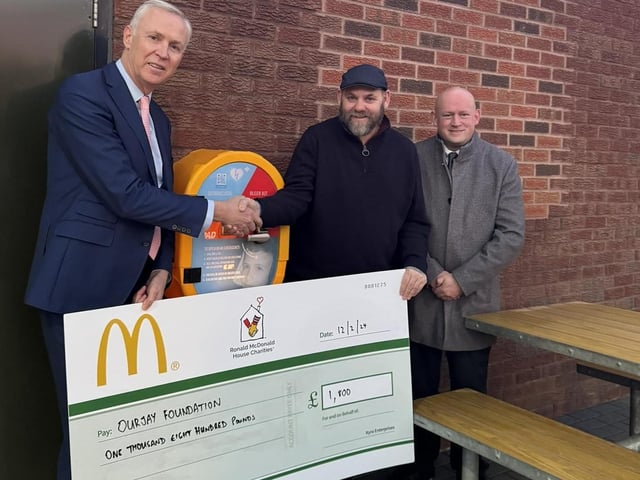 Glynn, McDonald's Franchisee, pictured handing over a contribution of £1800 for Our Jay Foundation with Geoff, McDonald's store manager).