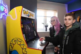Visitor Josh Lattimore tries out his luck on the Pac-Man machine in the Robin showhome