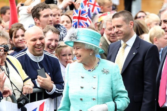 The Queen beams as the crowds cheer her outside the Corby Cube, June 2012