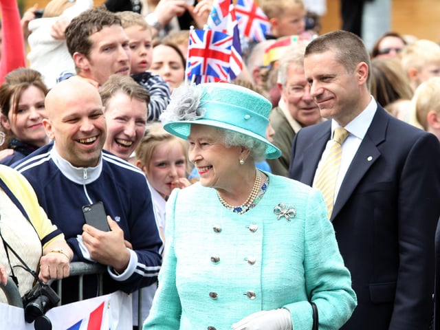 The Queen beams as the crowds cheer her outside the Corby Cube, June 2012