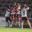 NORTHAMPTON, ENGLAND - OCTOBER 18: Josh Tomlinson of Northampton Town celebrates after scoring his sides first goal during the Papa John's Trophy match between  Northampton Town and Arsenal U-21 at Sixfields on October 18, 2022 in Northampton, England. (Photo by Pete Norton/Getty Images)
