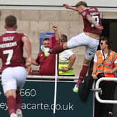 Mitch Pinnock kicks the corner flag in delight after scoring an 'outrageous' winning goal against Peterborough United at Sixfields. (Photo by Pete Norton/Getty Images)