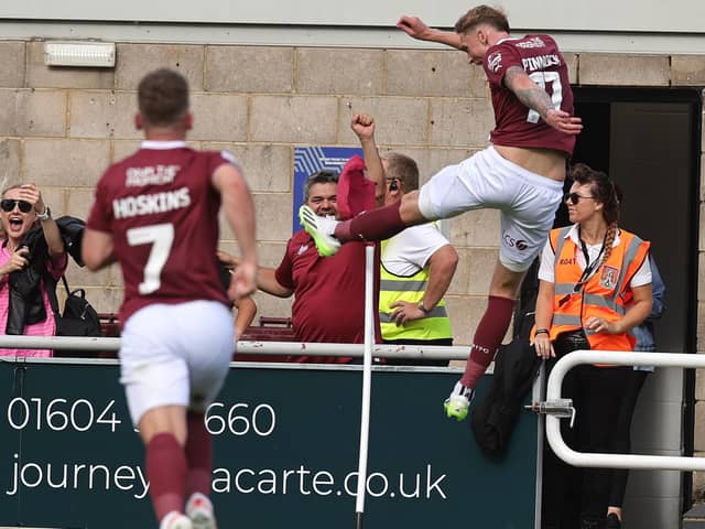 Mitch Pinnock kicks the corner flag in delight after scoring an 'outrageous' winning goal against Peterborough United at Sixfields. (Photo by Pete Norton/Getty Images)