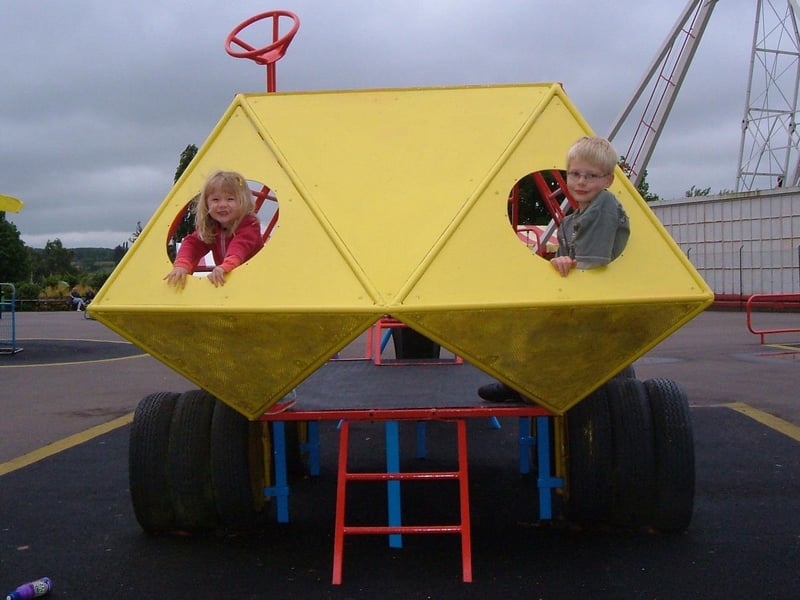 WIcksteed Park Charlotte and Alex Wells playing on the top playground's moon buggy