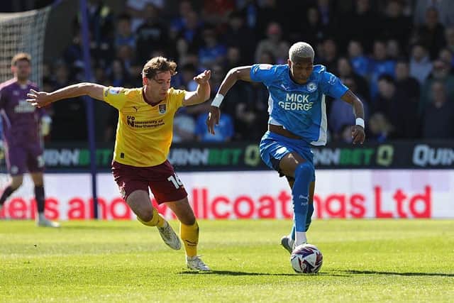 Malik Mothersille drives away from Terry Taylor during the Sky Bet League One match between Peterborough United FC and Northampton Town FC at Weston Homes Stadium on April 05, 2025 in Peterborough, England. (Photo by Pete Norton/Getty Images)