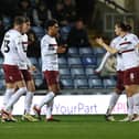 Will Hondermarck is congratulated by his team-mates after heading Cobblers level against Oxford United.