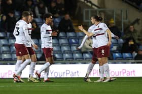Will Hondermarck is congratulated by his team-mates after heading Cobblers level against Oxford United.